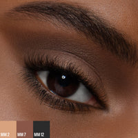 A female wearing two shades of the 
Master Mattes® Eyeshadow Palette: The Original.