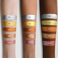 A arm swatch featuring all shades of the Master Metals® Eyeshadow Palette on three different skin tones. 