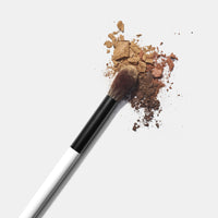 Makeup By Mario's Ef2 Blending Eye and Face makeup brush dipped in eyeshadow.