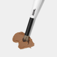 Makeup By Mario's F1 Dual-Ended Contour and blush brush dipped in foundation. 